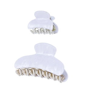 Detail view of marble textured white acrylic hair claws in large and small sizes