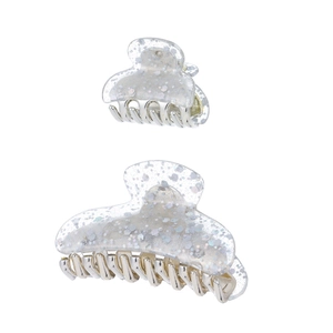 Detail of two glittery acrylic hair claw clips with silver metal teeth in large and small sizes