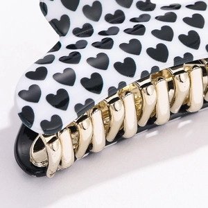 Chic black heart print hair claw clip with golden metal teeth for stylish hairstyling