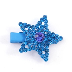 Detailed view of sky blue star-shaped hair clip with blue and purple crystal inlay