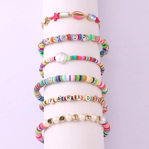 Detail of 6-piece bohemian beaded bracelet set with pearls, shells, and paradise letter beads