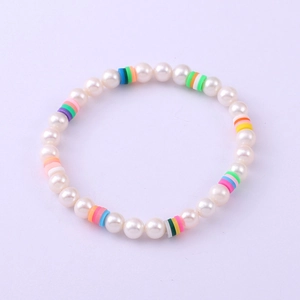 Detailed macro view of handmade colorful clay discs and white freshwater pearl bracelet