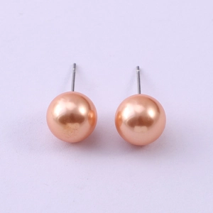 Close-up of 8mm champagne glass pearl earrings with silver posts in a minimalist style