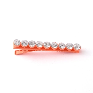 Detail showing matte orange pink alligator clip with nine sparkling inlaid rhinestones