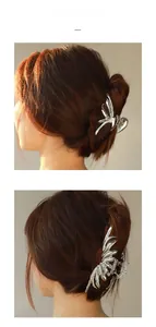 Detail of silver liquid metal butterfly hair claw clips on long brown hair