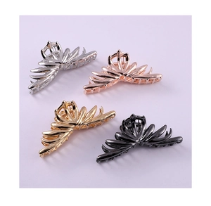Detail view of four butterfly metal hair claws in gold, silver, rose gold, and black colors