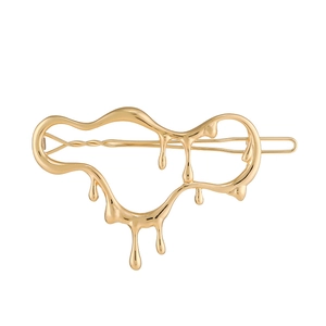 Pince à cheveux dorée au design de lave liquide avec une finition métallique polie