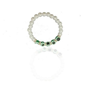 Detail of baroque pearl bracelet featuring green evil eye beads and crystal spacers