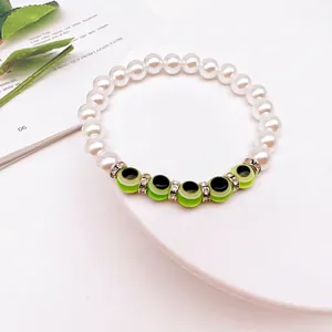Detail of baroque pearl bracelet with green evil eye beads and sparkling spacers