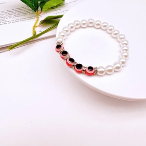 Detail shot of Baroque pearl evil eye bracelet with rhinestones and metal spacers