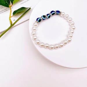 Detail of baroque pearl bracelet with blue evil eye beads and sparkling metal spacers