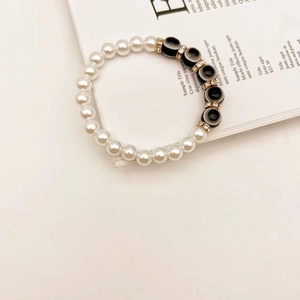 Close-up of Turkish evil eye bracelet with baroque pearls and gold rhinestone spacers
