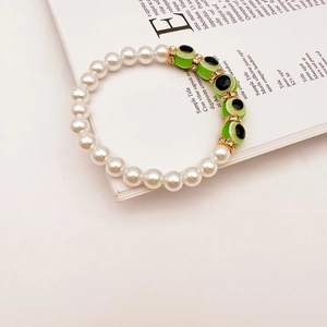 Handmade Baroque pearl bracelet with green Turkish evil eye beads and golden accents