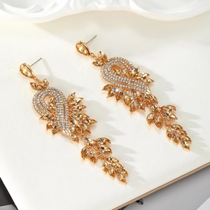 Close-up of gold dangle earrings with champagne rhinestones and sparkling crystal fringe