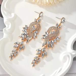 Detailed macro view of elegant gold-toned drop earrings with marquise-cut crystal stones