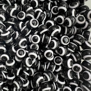Macro shot of circular evil eye beads in black and white for DIY jewelry making