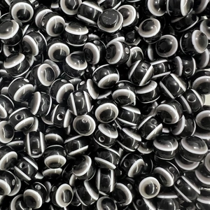 Macro shot of polished black and white striped agate beads for DIY jewelry making