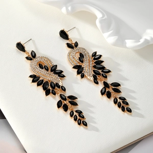 Detail of long dangle earrings with black marquise stones and white rhinestones decoration