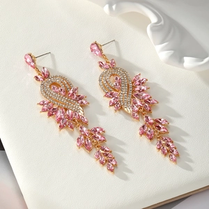 Detail of elegant gold-tone drop earrings with pink marquise crystals and pavé diamonds