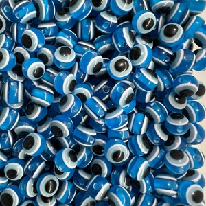 Macro shot of blue translucent Evil Eye loose beads for DIY jewelry and crafts making