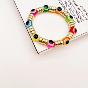 Buntes Evil Eye Perlenarmband mit goldenen Akzenten auf einem modischen weißen Hintergrund