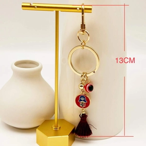 Detail of 13cm Turkish Evil Eye keychain with Hamsa Hand charm and red silk tassel