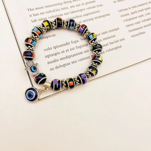 Hamsa Hand and Evil Eye charms on colorful beaded stretch bracelet with black beads