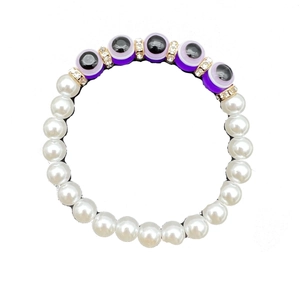 Baroque pearl bracelet featuring purple evil eye beads and sparkling crystal spacers