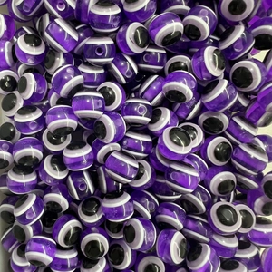 Macro detail of purple translucent resin evil eye spacer beads for DIY jewelry making