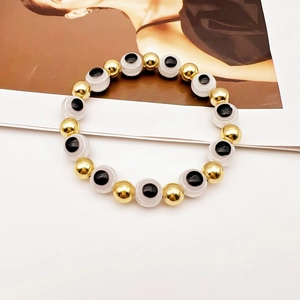 Bracciale elastico con perline dorate e ciondolo Evil Eye per un look minimalista