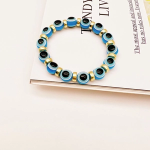 Detailed view of Turkish Evil Eye beaded bracelet with blue charms and gold accents