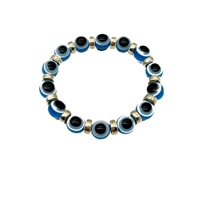 Elastic beaded Evil Eye bracelet with blue beads and golden metal spacers on white