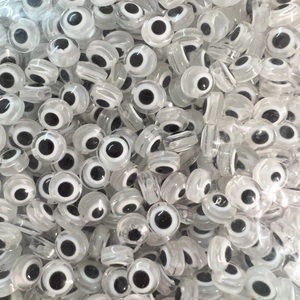 Macro shot of assorted flat evil eye beads for DIY jewelry making and handicraft accessory