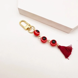 Turkish evil eye keychain with gold lobster clasp and dark red tassel charm for bags
