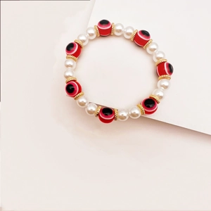 Pulsera bohemia de perlas con ojo turco y cuentas de vidrio de colores y detalles dorados