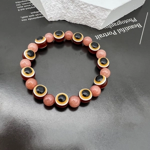 Close-up of Evil Eye beads and translucent natural stone beads on a handmade bracelet