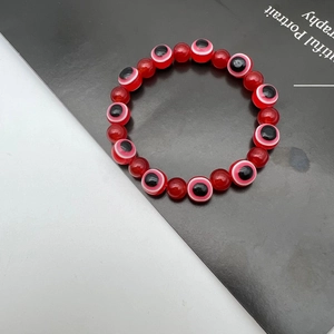 Elastic beaded bracelet with red crystal beads and protective evil eye lucky charms