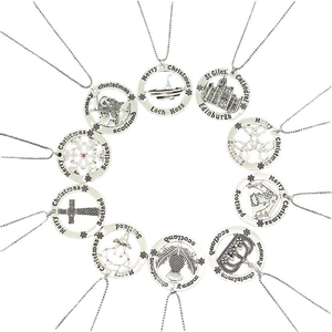 Close-up of silver Christmas and Scottish themed hollow pendants with elk and cross designs