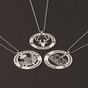 Detail of silver Christmas pendants with reindeer, thistle, and crown hollow designs