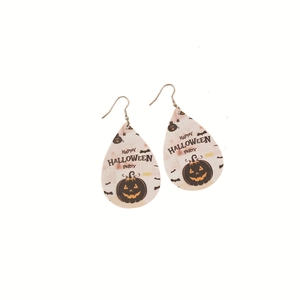 Detailed macro view of teardrop PU leather earrings featuring Halloween pumpkin motifs