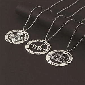 Detailed close-up of hollow silver necklaces featuring Loch Ness and Scotland motifs