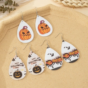 Detail of three pairs of Halloween teardrop earrings with pumpkin and bat prints on PU leather