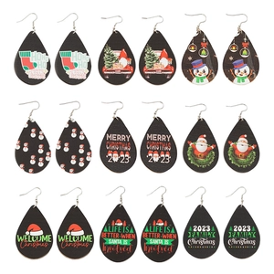 9 pairs of teardrop Christmas wood earrings featuring Santa and snowman patterns
