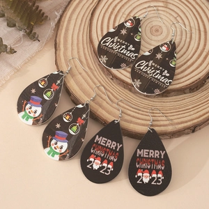 Three pairs of teardrop wooden Christmas earrings with snowman and festive prints