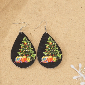 Detailed view of teardrop wood earrings featuring a festive Christmas tree and gifts