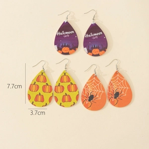 Detail of Halloween faux leather leaf earrings with pumpkin and spider web motifs