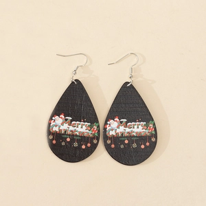 Detailed view of teardrop wood earrings with Santa and Merry Christmas print