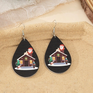 Detail of wooden teardrop earrings with hand-painted Santa and snowman Christmas motifs