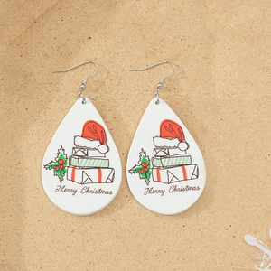 Detailed view of Christmas teardrop wooden earrings with Merry Christmas print design