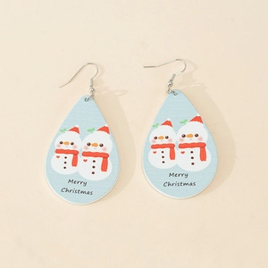 Detail of teardrop wood earrings featuring cartoon snowmen and Merry Christmas print